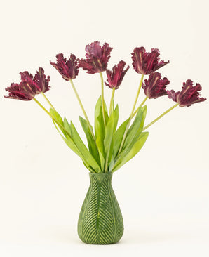 The Silk artificial flower bouquet French Parakeet Tulip purple features dark purple, fringed tulips with long green stems in a vase with green leaf motif, creating a striking display against a white background.