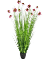The Artificial Grass Plant Chrysanthemum 180 cm fire retardant is an artificial plant in a pot with high, thin green grass-like leaves and pink chrysanthemum blossoms on long stems, depicted against a white background.