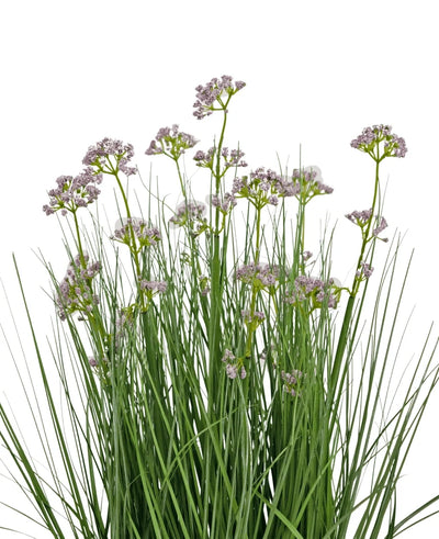 The Artificial Grass Leek Flower Onion Grass Pot 60cm has high, thin green leaves and bunches of small, delicate light purple flowers on long stems. The arrangement is fire retardant and depicted against a white background.