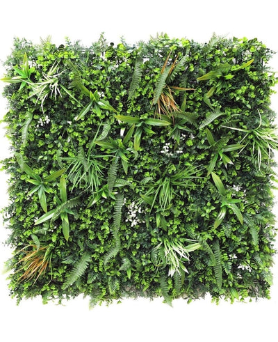 De Kunsthaag mat Savanne 100x100 cm is een vierkant groen wandpaneel dicht bedekt met UV-beschermde kunstvarens, grasachtige bladeren en kleine witte bloemen voor een weelderige, natuurlijke uitstraling in elke ruimte.