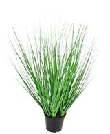 The Artificial Grass Plant Onion 50 cm fire retardant has long, thin, green grass-like leaves spreading outwards from the center, presented in a pot against a plain white background.